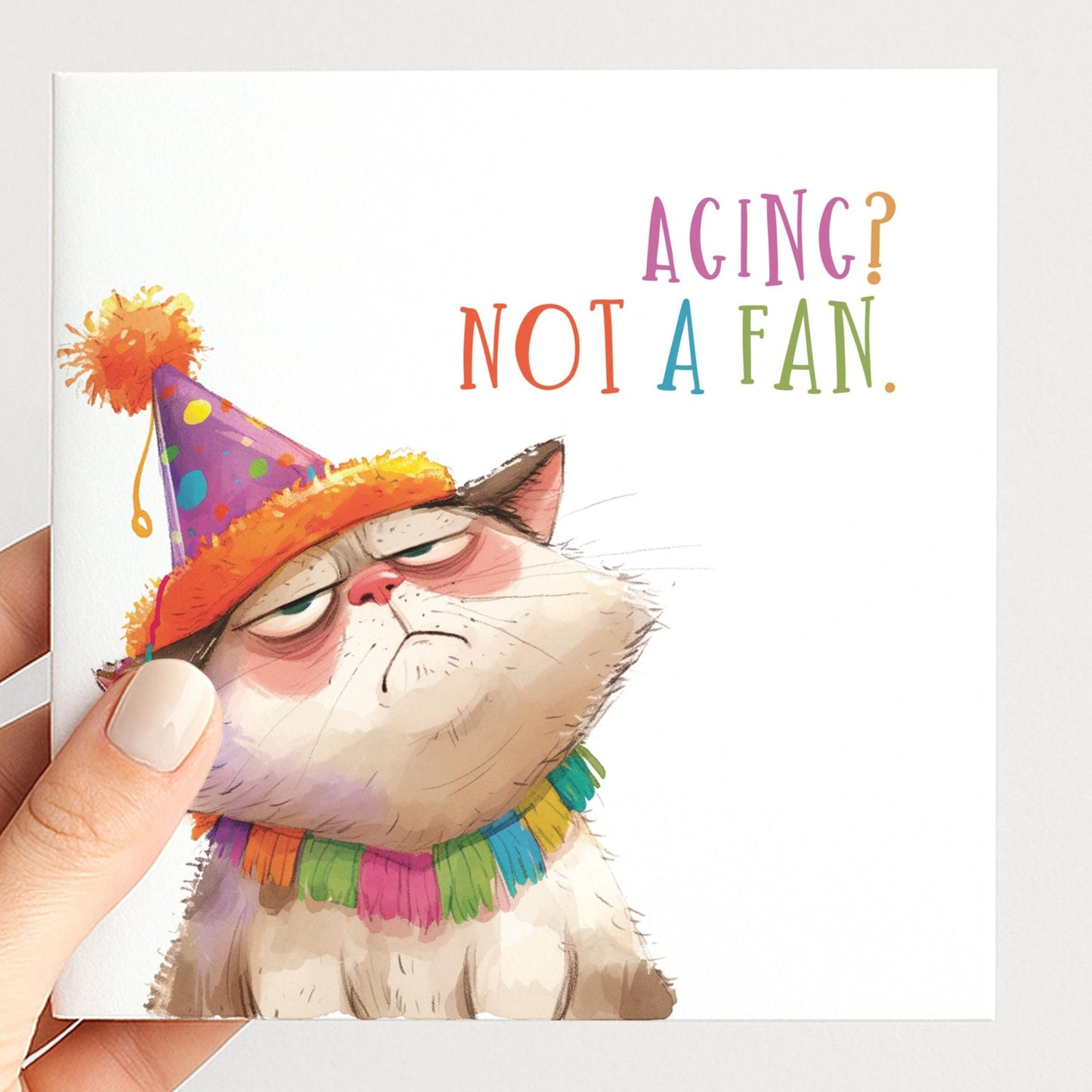 Funny Cat Birthday Card by Whimsi Lilley featuring humorous cat illustration and the message "Aging? Not A Fan" for birthdays.