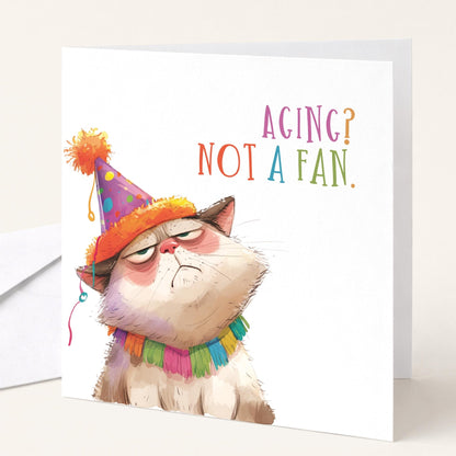 Funny cat birthday card by Whimsi Lilley featuring humorous artwork and the message "Aging? Not A Fan" in playful design.