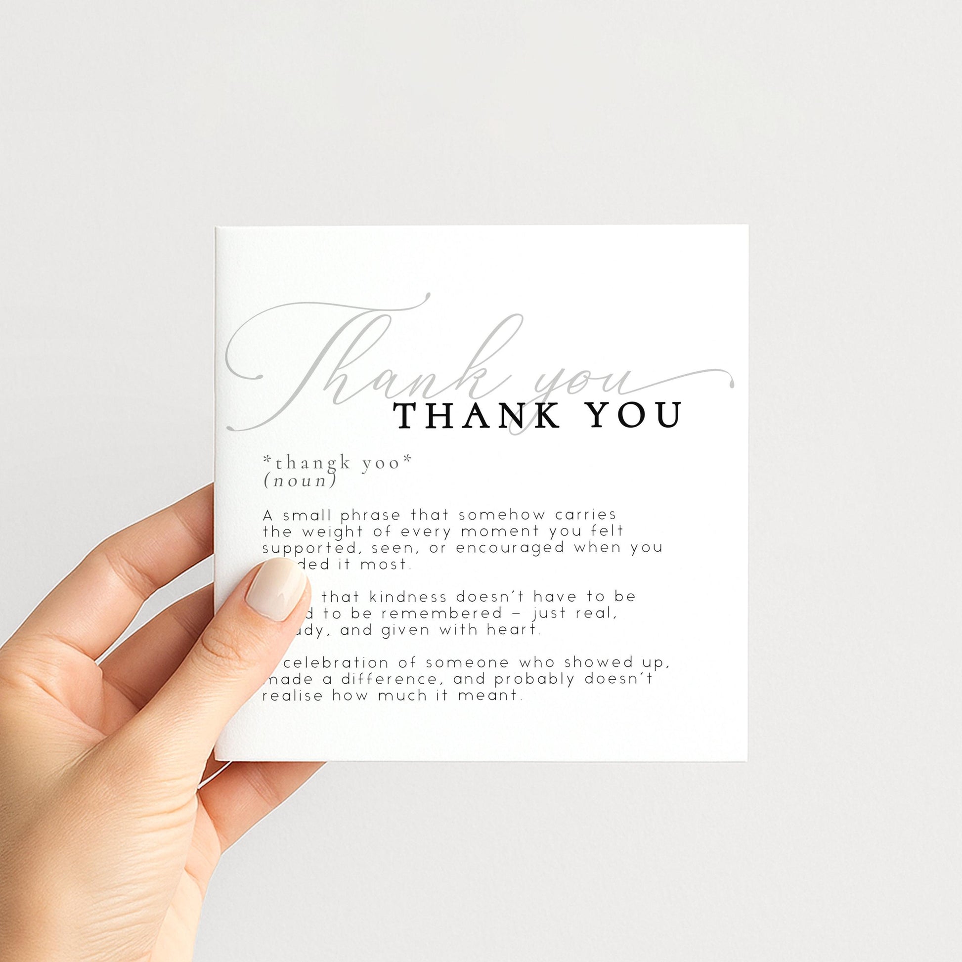 a hand holding a card with a definition of "Thank You" written on it.