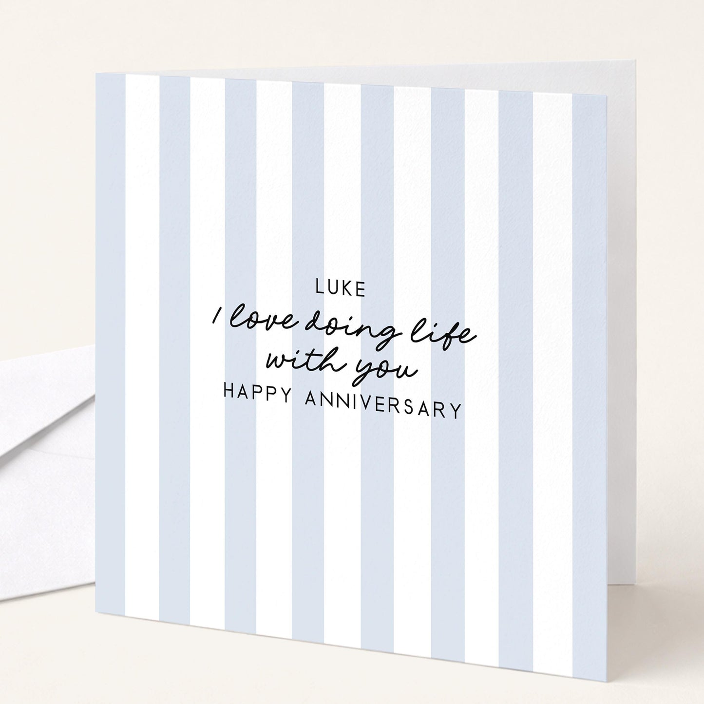 A personalised anniversary card with a soft blue stripe design and the sentiment I love doing life with you. Add a name!, printed on 300gsm card