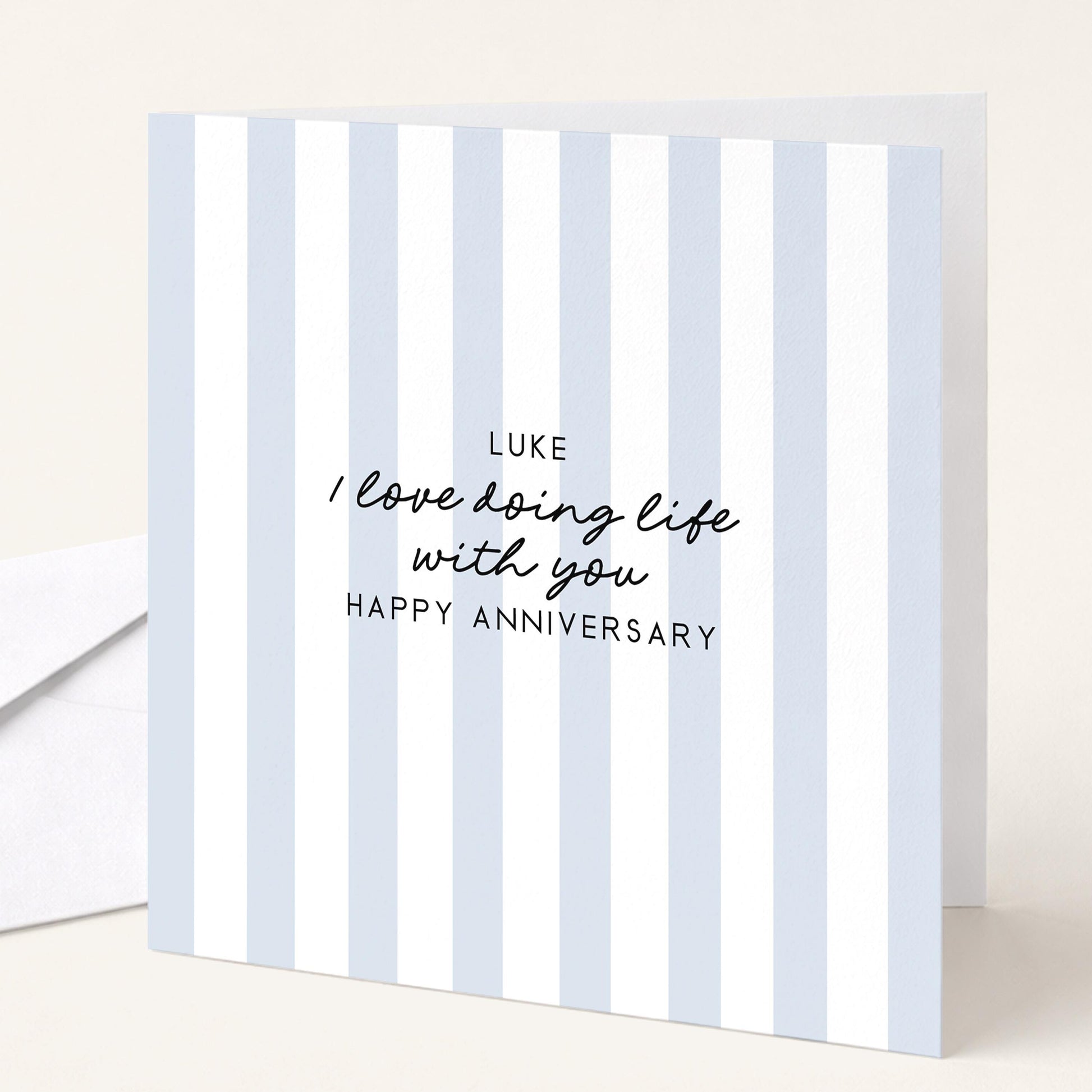 A personalised anniversary card with a soft blue stripe design and the sentiment I love doing life with you. Add a name!, printed on 300gsm card
