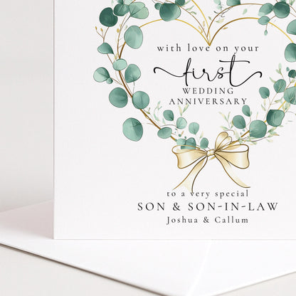 A personalised first wedding anniversary card for son and son-in-law featuring a beautiful eucalyptus heart wreath, printed on 300gsm card