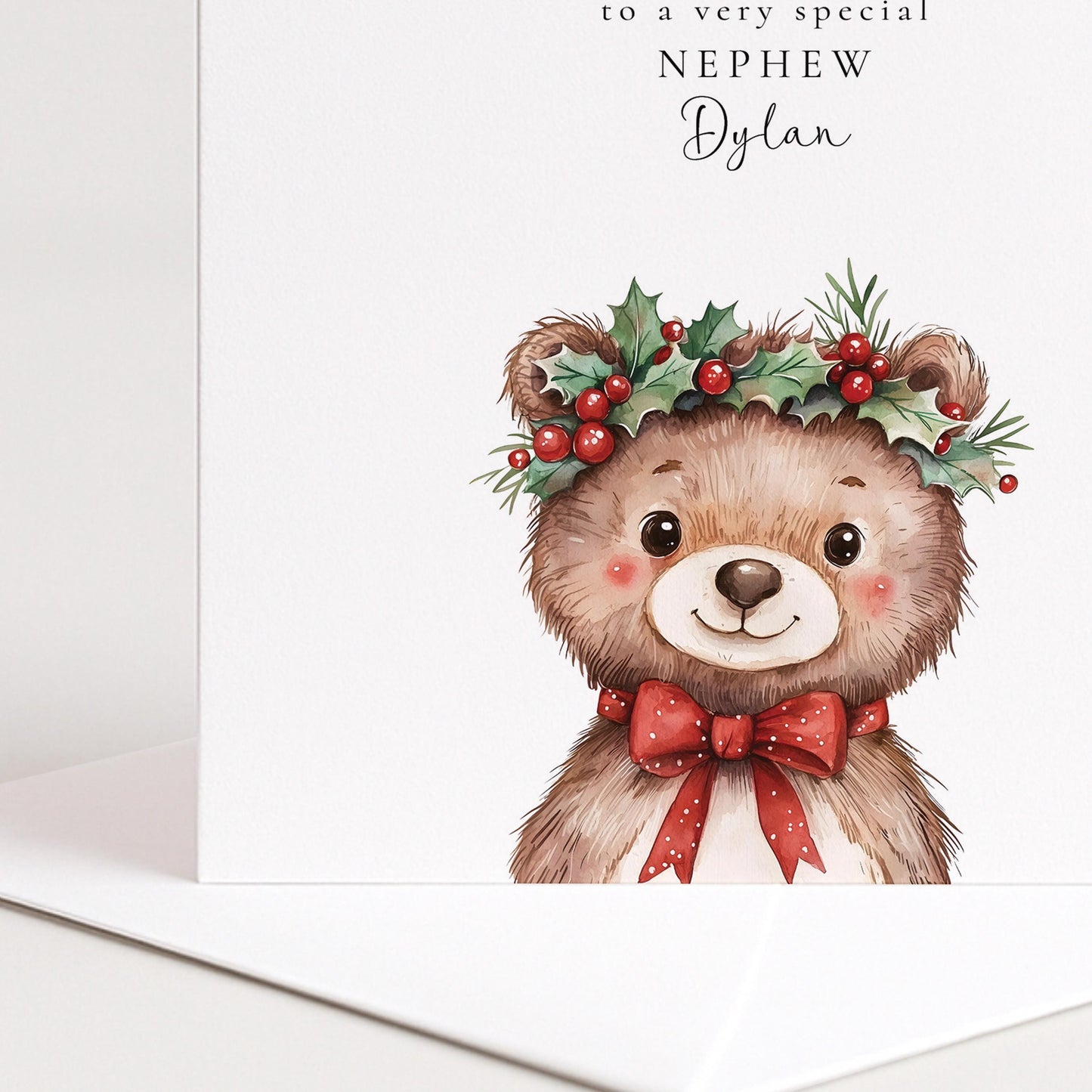 Cute holly crown bear Christmas card for a special nephew, personalised with his name, printed on 300gsm card