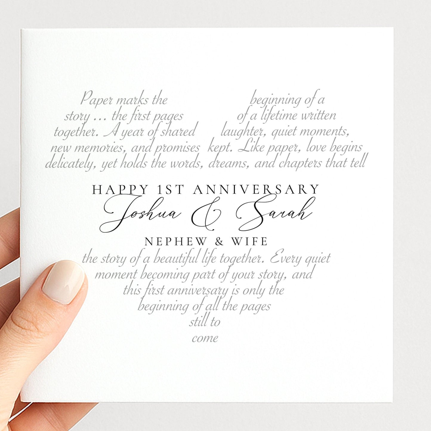 The image is a hand holding a card with text on it. The text appears to be a message or announcement related to a couple's first anniversary celebration.