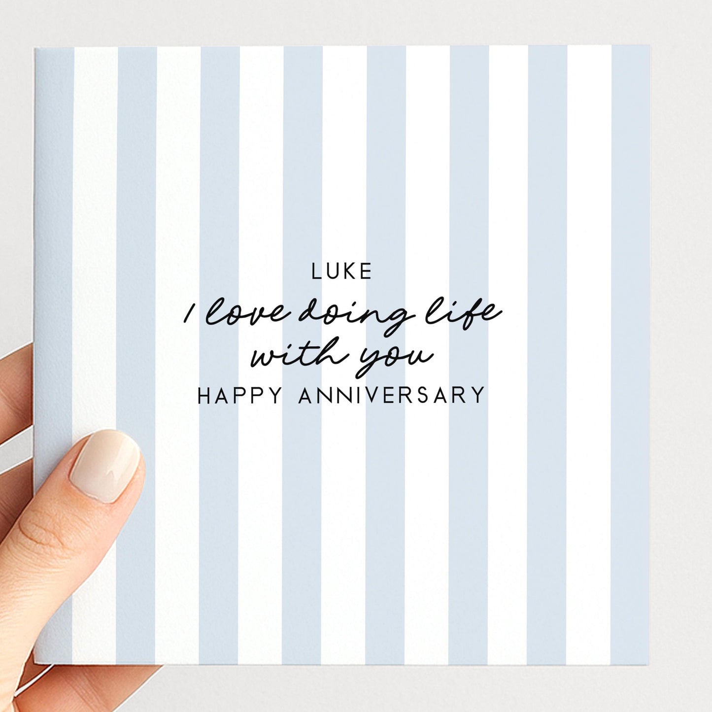 A personalised anniversary card with a soft blue stripe design and the sentiment I love doing life with you. Add a name!, printed on 300gsm card