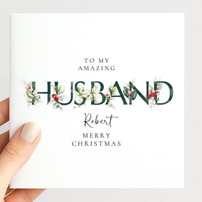 Personalised Christmas card for husband with festive floral HUSBAND letter typography and custom name, printed on 300gsm card