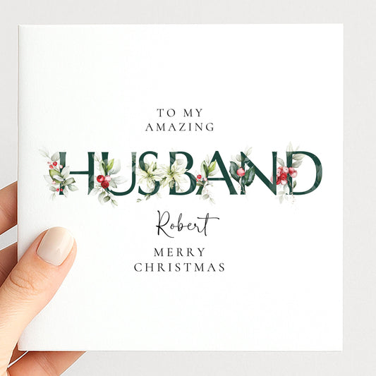 Personalised Christmas card for husband with festive floral HUSBAND letter typography and custom name, printed on 300gsm card