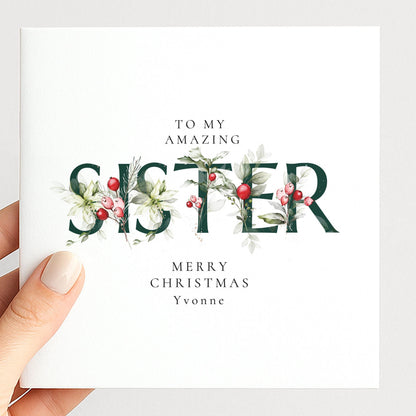 Personalised Christmas card for sister with festive floral SISTER letter typography and custom name, printed on 300gsm card