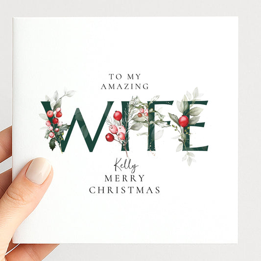 Personalised Christmas card for wife with festive floral WIFE letter typography and custom name, printed on 300gsm card
