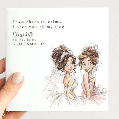 Brunette bride holding a "Will You Be My Bridesmaid" card from Whimsi Lilley, featuring elegant floral design and heartfelt message.